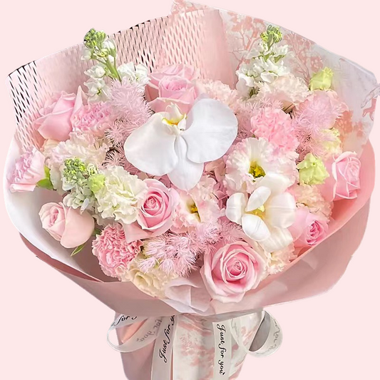 Bouquet of pink roses, pink carnations, lilies, and phalaenopsis orchids