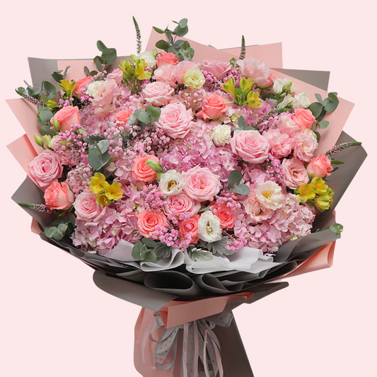 Large pink roses, white lisianthus, hydrangea, baby's breath