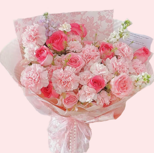 8 pink carnations mixed with 9 pink roses and 3 violets