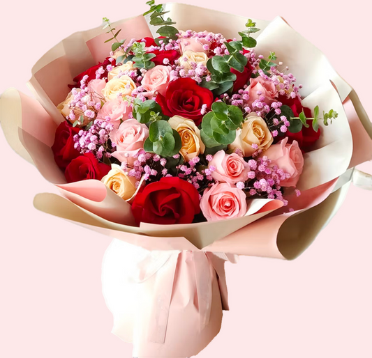 33 roses in 3 shades of red, champagne, and pink, with baby's breath and eucalyptus leaves