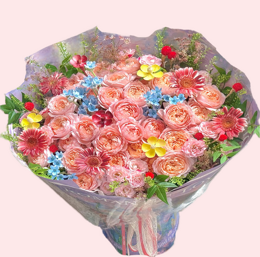 Bouquet of pink and orange Juliet roses, gerbera with blue star, yellow flowers and globe amaranth